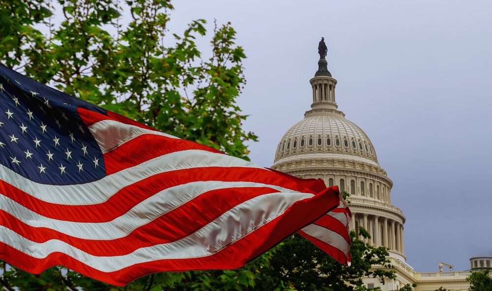 The US Capitol building with a waving American flag, Washington DC