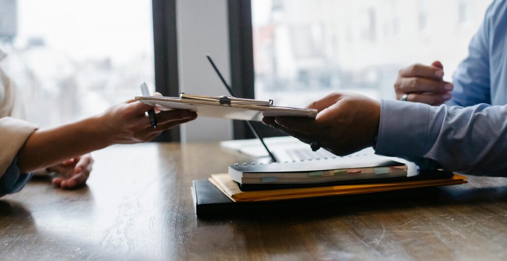 A professional reviewing a resume across the table